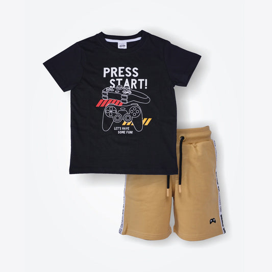 Black t-shirt with 'Press Start!' graphic and beige shorts on a white background