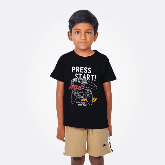 Child wearing a black t-shirt with 'Press Start!' design on a white background